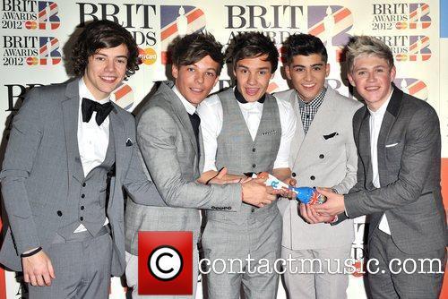 if you wach video´s you should watch the diary´s and spin the harry and watch megamind and watch 
twitcam´s that´s so nice to watch that zayn is the quiet
harry is the flirt one liam is the daddy direction one
and niall is the irish one and louis funny one,
and here is the pic from when they won the brit  awards with their hit single what makes you beautiful
