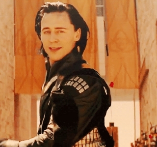 I dreamed I was having a nightmare (so weird. that happens all the time) and Loki came and woke me up. He held me and told me it was going to be alright. I felt so safe and warm and content. Then, the Lady Sif came out of nowhere and started yelling at Loki about being a traitor. I stood up and basically told her to shut up, though it was much less nicely phrased. Loki and Sif looked at me, and Loki said, "Hm. I suppose I ought not to get on your bad side." SIf turned with a huff and left. My cell phone rang, and it was my sister telling me that Thor was in her living room, and what should she do? I looked at Loki and smiled and told her to just go with it. As I hung up Loki looked at my background which was my favorite picture of him (shown below) and he looked at me and raised his eyebrows. I blushed and said, "Well, what do you expect? I don't go for the warrior types like Thor." Loki smiled again and he kissed me. I was surprised at first then I kissed him back. My sister called me again, interrupting us, and I yelled at her that I was busy. "Busy kissing Loki?" she said back. I looked out my window and she was standing in my driveway with her arms crossed with Thor standing behind her trying not to laugh. Then...I woke up. 