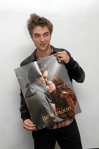  here is my Robert holding a poster of him and Kristen Stewart as their Twilight characters from New Moon.