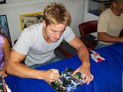  Justin signing autographs at a convention