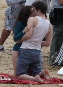  my Robert barefoot as he and Kristen film a scene from BD part 1 on the beach<3