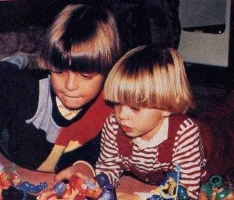  Little Matthew (red overalls) with plastic toys in front of him. :)