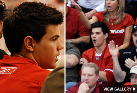  here is Taylor Lautner at a Detroit Wings hockey game,wearing a replica team jersey.