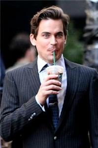  Matt Bomer with a drink that has a straw.