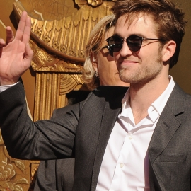 here is my baby showing one of his hands as he waves to some fans just before he,Kristen and Taylor cemented their hands and feet in cement<3