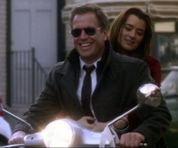 Michael Weatherly as Tony Dinozzo on a motor bike with Ziva David behind him on the Show NCIS.