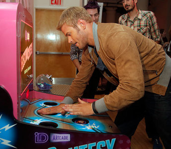 here is Kellan Lutz playing an arcade game(I know you said a video game,but this is the closest I could find,is that okay?)