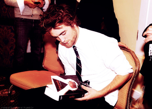  my baby holding the Twilight book<3