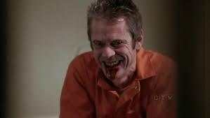  C Thomas smiling deviously and bloody on Criminal Minds as character "George Foyet"