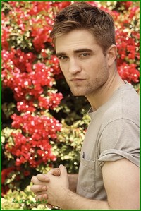 my handsome Robert with red flowers behind him<3