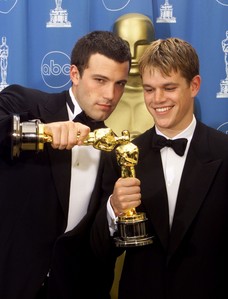  Ben Affleck and Matt Damon holding their Oscars for winning Best Original Screenplay for Good Will Hunting.