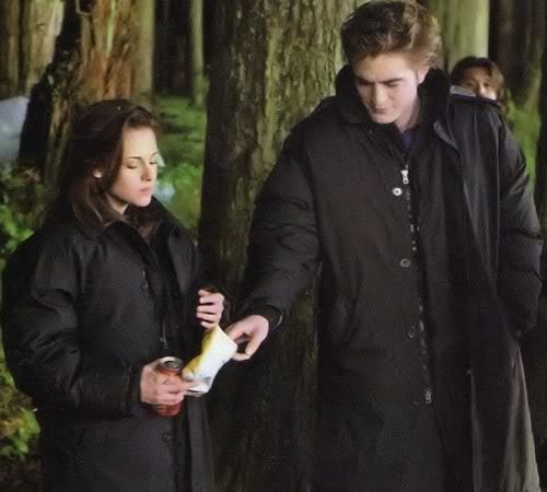 my handsome Robert with Kristen Stewart on the set of New Moon grabbing some of her chips<3