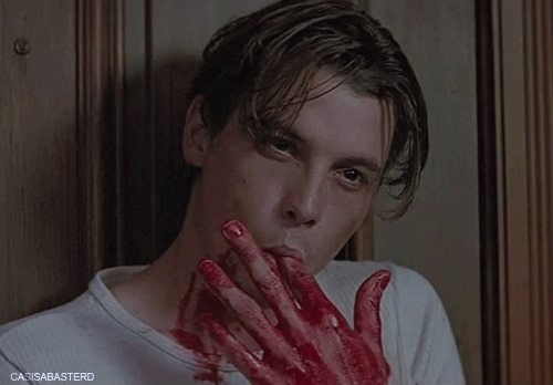 Billy Loomis,played by Skeet Ulrich in Scream tasting his own blood(which is actually corn syrup)
