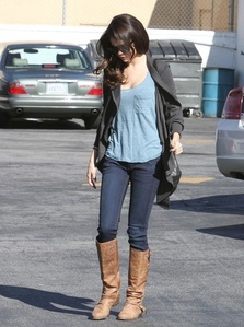 Here. Brown boots and blue top

For a bigger view:
http://images6.fanpop.com/image/photos/34900000/Sel-selena-gomez-34902056-443-594.jpg