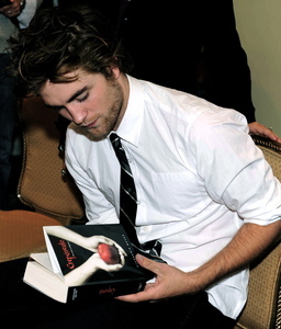  my handsome baby holding a book(yes it's the Twilight book)<3