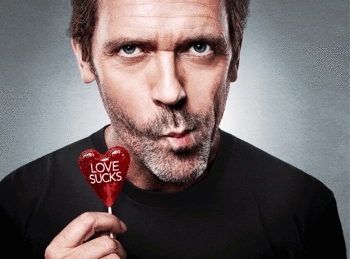  Hugh Laurie as House holding a lollipop