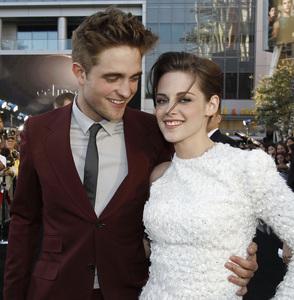  my handsome baby with Kristen Stewart who is in a white dress at the Eclipse premiere<3
