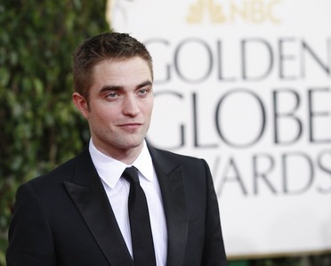  my handsome baby on the red carpet at the Golden Globes,with the GG sign behind him<3