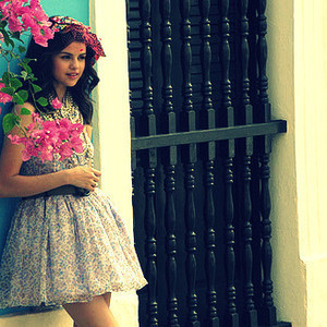 selena with flowers..
http://images4.fanpop.com/image/answers/1591000/1591161_1306249047712.32res_500_281.jpg
