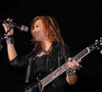 Demi with a guitar