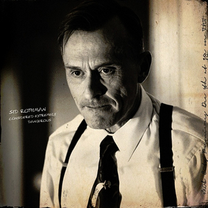  Robert Knepper as Sid Rothman in Mob City. I don't <i>think</i> it's a smile.
