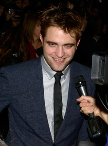  Robert with a mic in front of his face<3