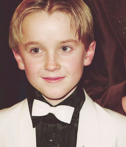  a young Tom Felton wearing a bow tie<3