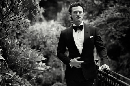 Luke Evans surrounded by bushes<3