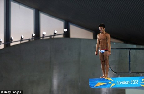 Tom standing on top of a diving board from the 2012 Olympics<3