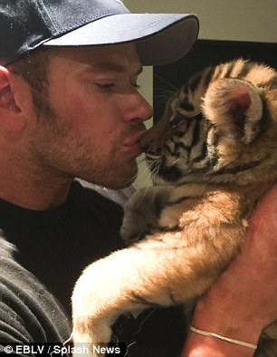  Kellan holding a cute tiger cub<3