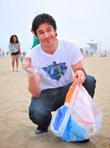 Ian helping clean up litter off a beach