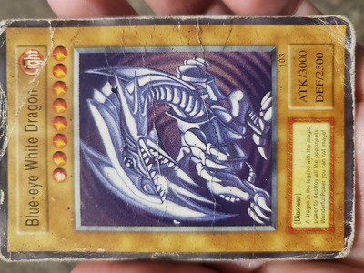 I know this is over a year old but did you ever find out why? My husband has the same card. Blue-eye White Dragon.