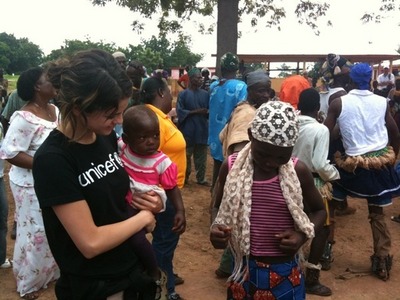 Post a photo of Selena helping poor people.