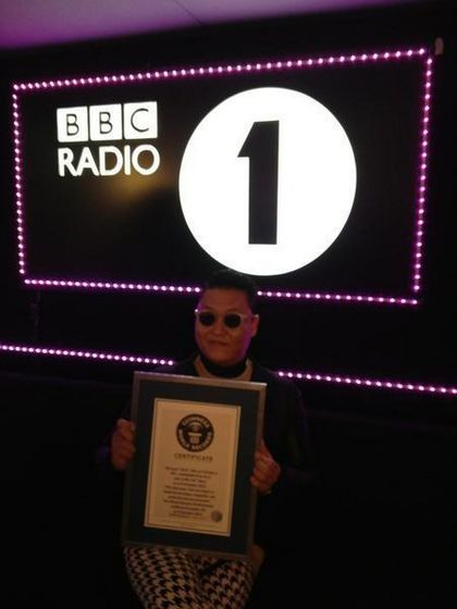 Psy holding his certificate  ~