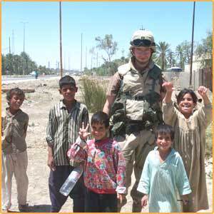  iraqi kids taking pic with american solier