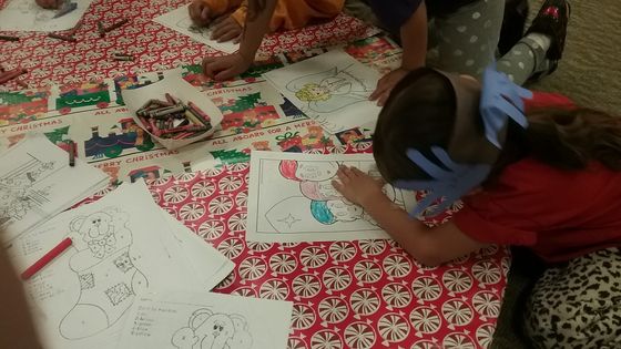 Child colors in a Davey and Goliath coloring page.