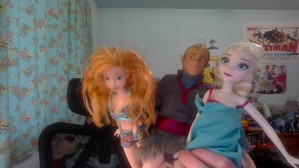 Anna, Kristoff and Elsa modeling in their outfits