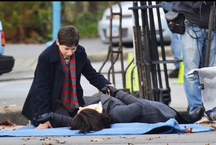 "In a recently leaked photo,  we see Henry kneeling over Regina who is flat on her back on the ground