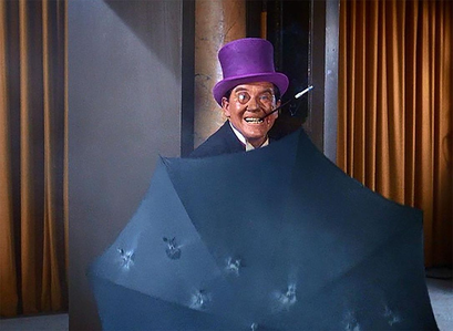 Burgess Meredith as the Penguin with an umbrella 