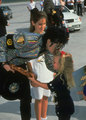 Michael and a little girl - michael-jackson photo