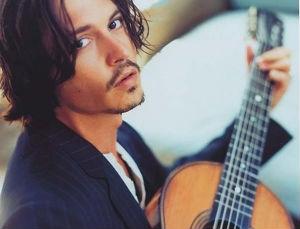Johnny Depp playing/holding the guitar