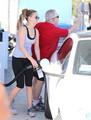 Jennifer Lawrence filling her car with gas as her dad flips off the papperazzi - jennifer-lawrence photo