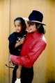 Michael holding a child - michael-jackson photo