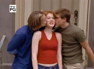 Eric and Jack giving Rachel a kiss