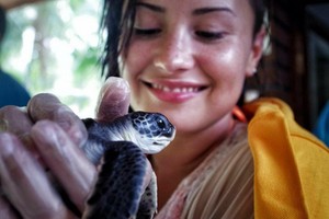  Demi became a Godparent of a tortuga at the Meridien Resort in Bora Bora - August 2014