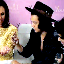 Harry showing how to put perfume on. x