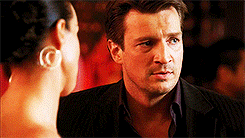Castle looking at Beckett