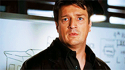 Castle looking at Beckett