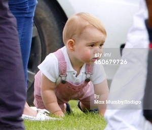  Prince George of Cambridge plays with a polo mallet as he
