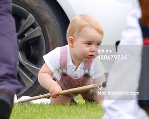  Prince George of Cambridge plays with a polo mallet as he